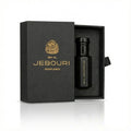 Black perfume oil bottle with gold text in a branded 'Ibn al Jebouri perfumes' box on a white background
